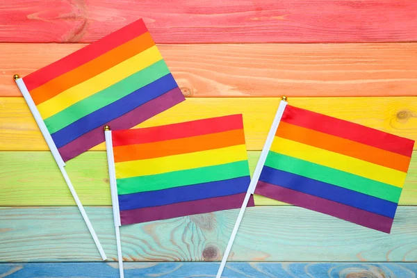 Bandera de arco iris en mesa de madera colorida — Foto de Stock