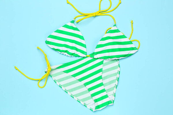 Fashion striped swimsuit on blue background