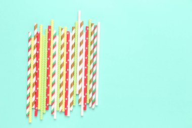 Mavi arkaplanda renkli kağıt pipetler