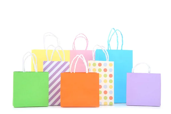 Pequenos sacos de compras de papel isolados no fundo branco — Fotografia de Stock