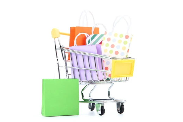 Small metal cart with shopping bags isolated on white background — Stock Photo, Image