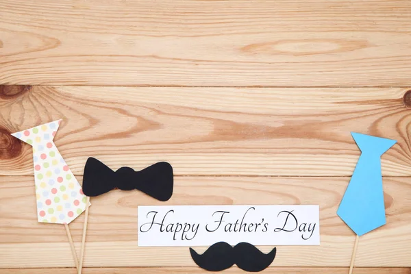 Text Happy Fathers Day with paper bow tie, mustache and necktie — Stock Photo, Image