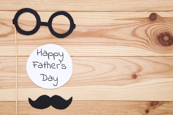 Text Happy Fathers Day with paper glasses and mustache on wooden — Stock Photo, Image