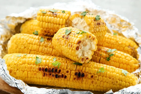 Grilled corn with green parsley in foil — Stock Photo, Image