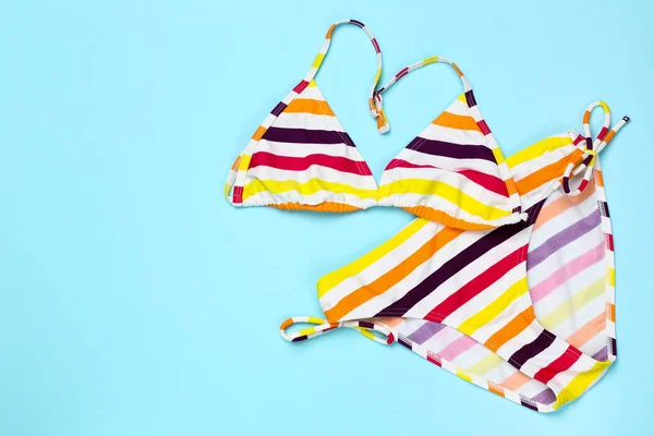 Fashion striped swimsuit on blue background — Stock Photo, Image