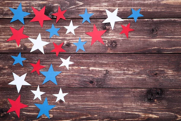 Colorful paper stars on brown wooden table