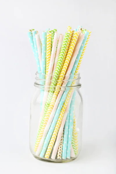 Colorful paper straws on white background