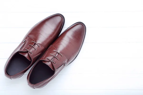 Male leather shoes on white wooden table — Stock Photo, Image