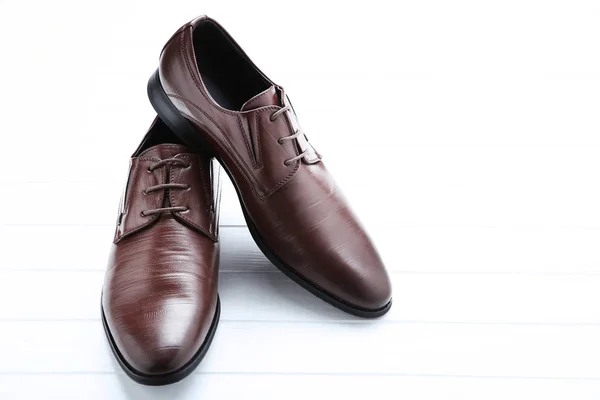 Male leather shoes on white wooden table — Stock Photo, Image