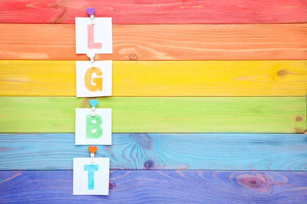 Papier met afkorting LGBT op kleurrijke houten tafel — Stockfoto