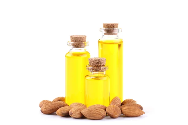 Almond and oil in bottles on white background — Stock Photo, Image