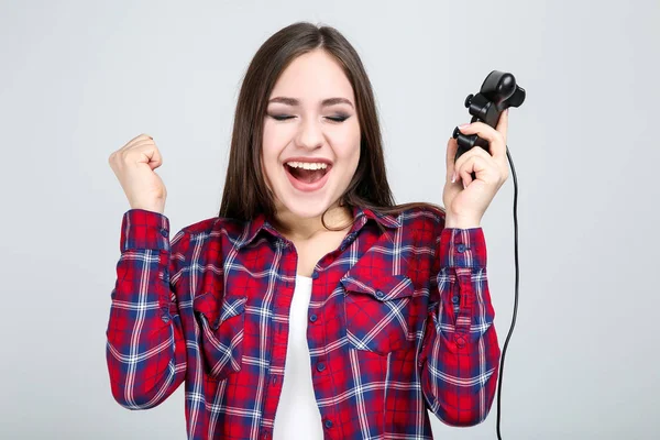 Mooi meisje met joystick op grijze achtergrond — Stockfoto