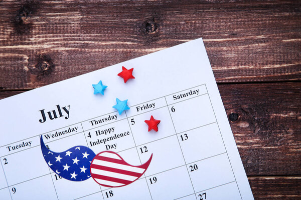 Text Happy Independence Day in calendar with paper stars and mus