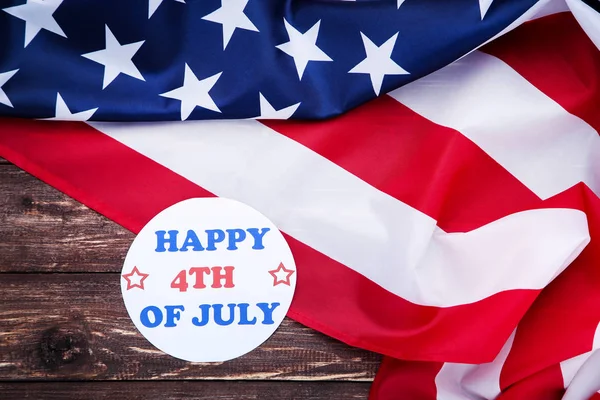 Tekst gelukkig 4 juli met Amerikaanse vlag op bruin houten tafel — Stockfoto