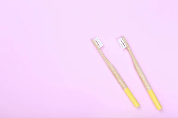 Bamboo toothbrushes on pink background — Stock Photo, Image
