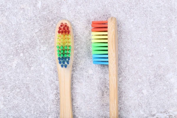 Bamboo toothbrushes on grey background — Stock Photo, Image