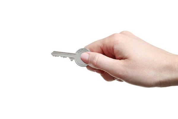 Female hand holding house key on white background — Stock Photo, Image