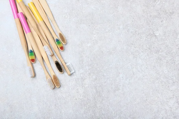 Bamboo toothbrushes on grey background — Stock Photo, Image