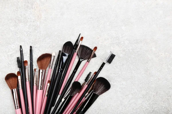 Set de pinceles de maquillaje sobre fondo gris — Foto de Stock