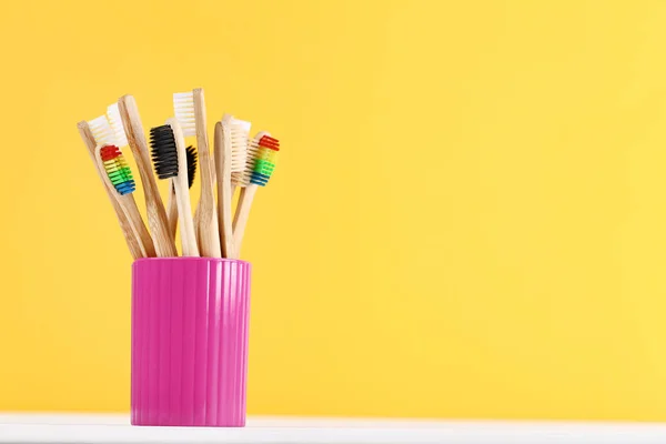 Bambusz fogkefék a kosárba sárga háttér — Stock Fotó
