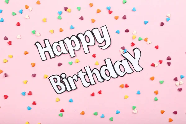 Text Happy Birthday with colorful sprinkles on pink background — Stock Photo, Image