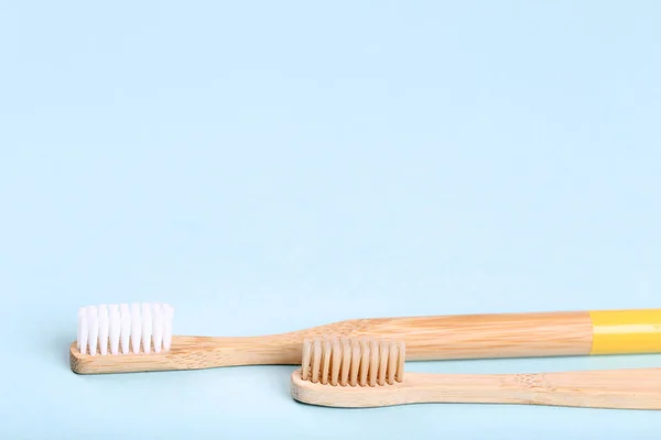 Bamboo toothbrushes on blue background — Stock Photo, Image