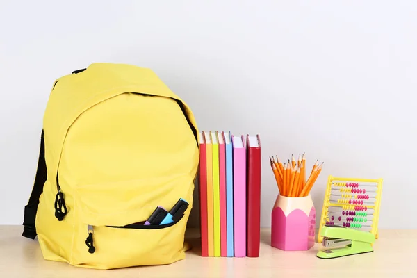 Backpack with school supplies on grey background — Stock Photo, Image