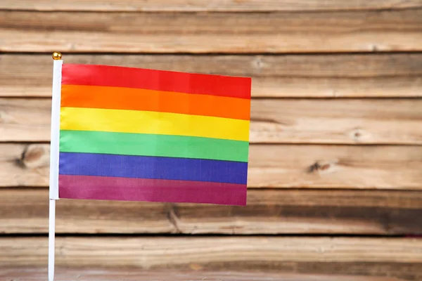 Bandera arco iris sobre mesa de madera marrón — Foto de Stock