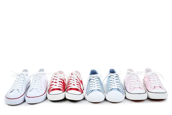 Diferentes zapatillas de deporte de colores sobre fondo blanco — Foto de Stock