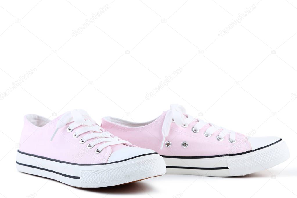 Pair of pink sneakers isolated on white background