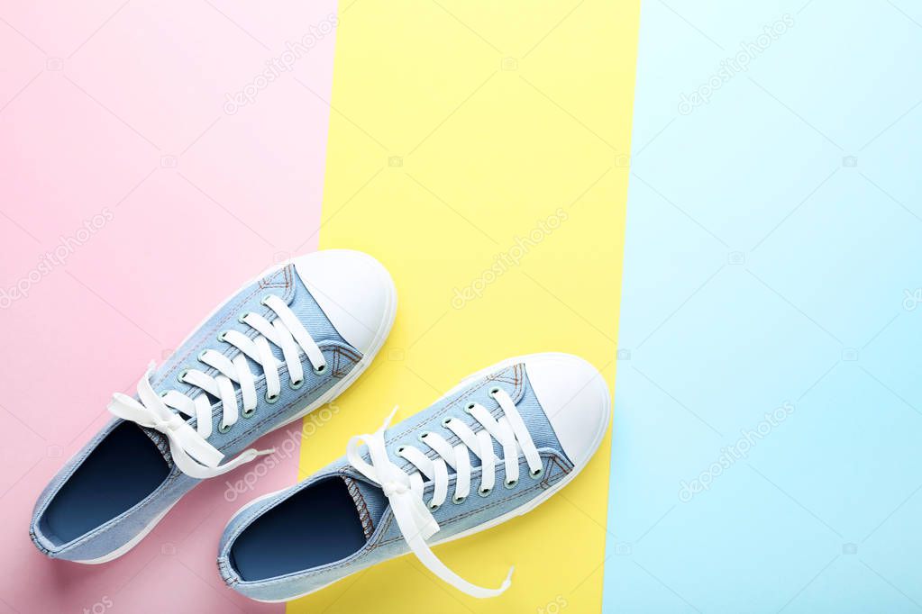 Pair of blue sneakers on colorful background