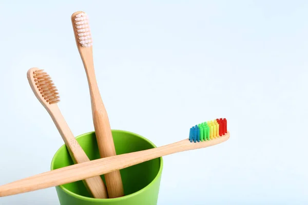 Bamboo toothbrushes with green basket — Stock Photo, Image