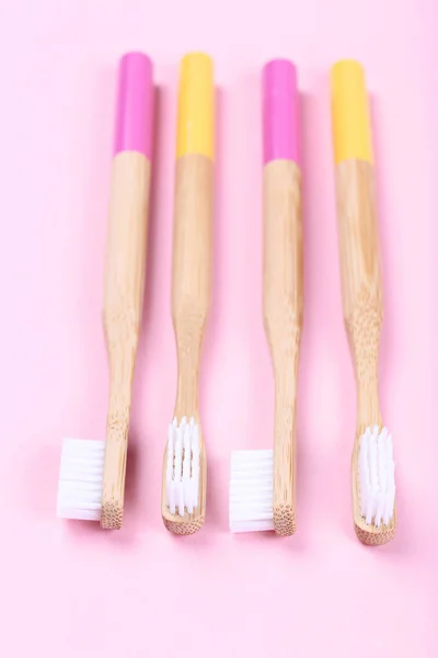 Bamboo toothbrushes on pink background — Stock Photo, Image