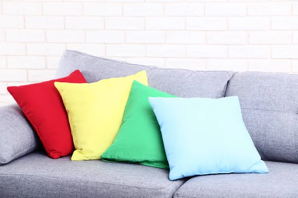 Colorful soft pillows on grey sofa — Stock Photo, Image