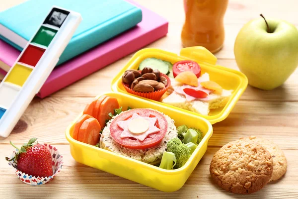 School lunch box with sandwich and vegetables on wooden table — Stock Photo, Image