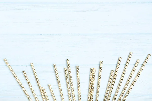Paper straws on white wooden table