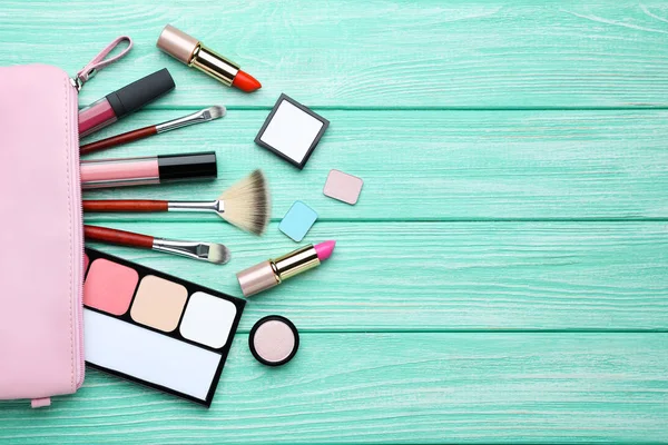 Makeup cosmetics on mint wooden table — Stock Photo, Image