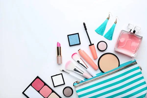 Makeup brushes and different cosmetics on white background — Stock Photo, Image