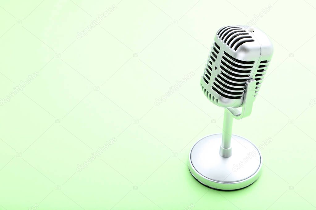 Vintage microphone on green background
