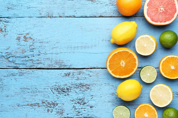 Citrus fruits on blue wooden table — Stock Photo, Image