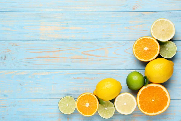 Citrus fruits on blue wooden table — Stock Photo, Image