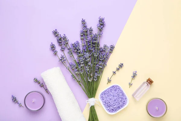 Lavender flowers with oil in bottle, candle and salt on colorful — Stock Photo, Image