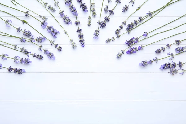 Lavender flowers on white wooden table — Stock Photo, Image