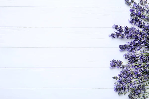 Lavender flowers on white wooden table — Stock Photo, Image