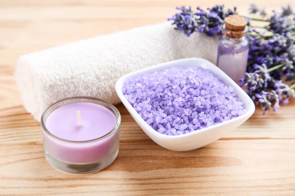 Lavender flowers with oil in bottle, salt in bowl and candle on — Stock Photo, Image