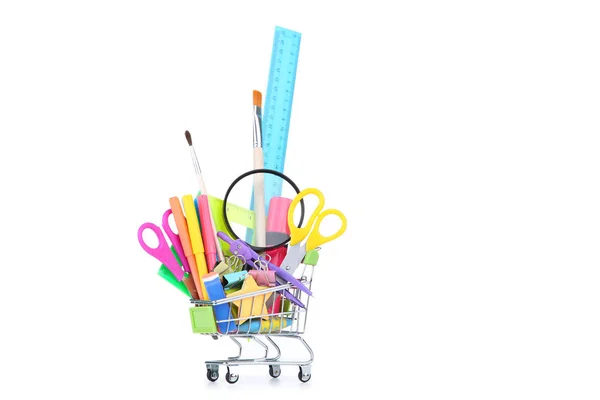 School supplies in shopping cart on white background — Stock Photo, Image