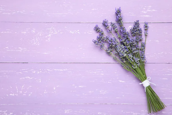 Lavender flowers on purple wooden table — Stock Photo, Image