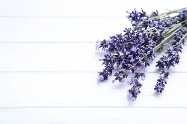 Lavender flowers on white wooden table — Stock Photo, Image