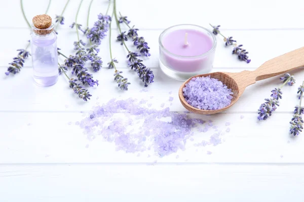 Lavender flowers with oil in bottle, candle and salt on white wo — Stock Photo, Image