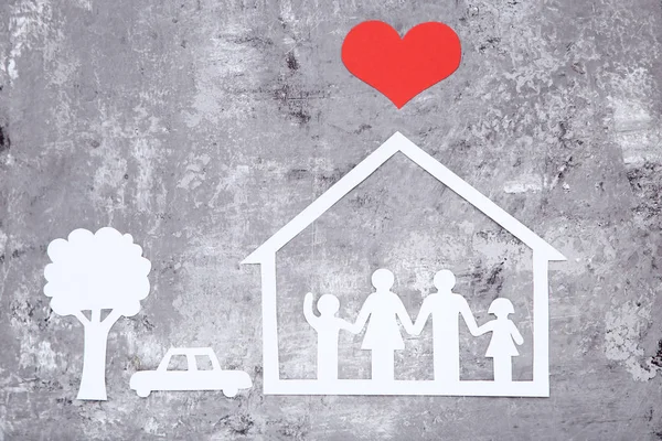 Figure di famiglia e di casa con cuore di carta, auto, albero su bac grigio — Foto Stock